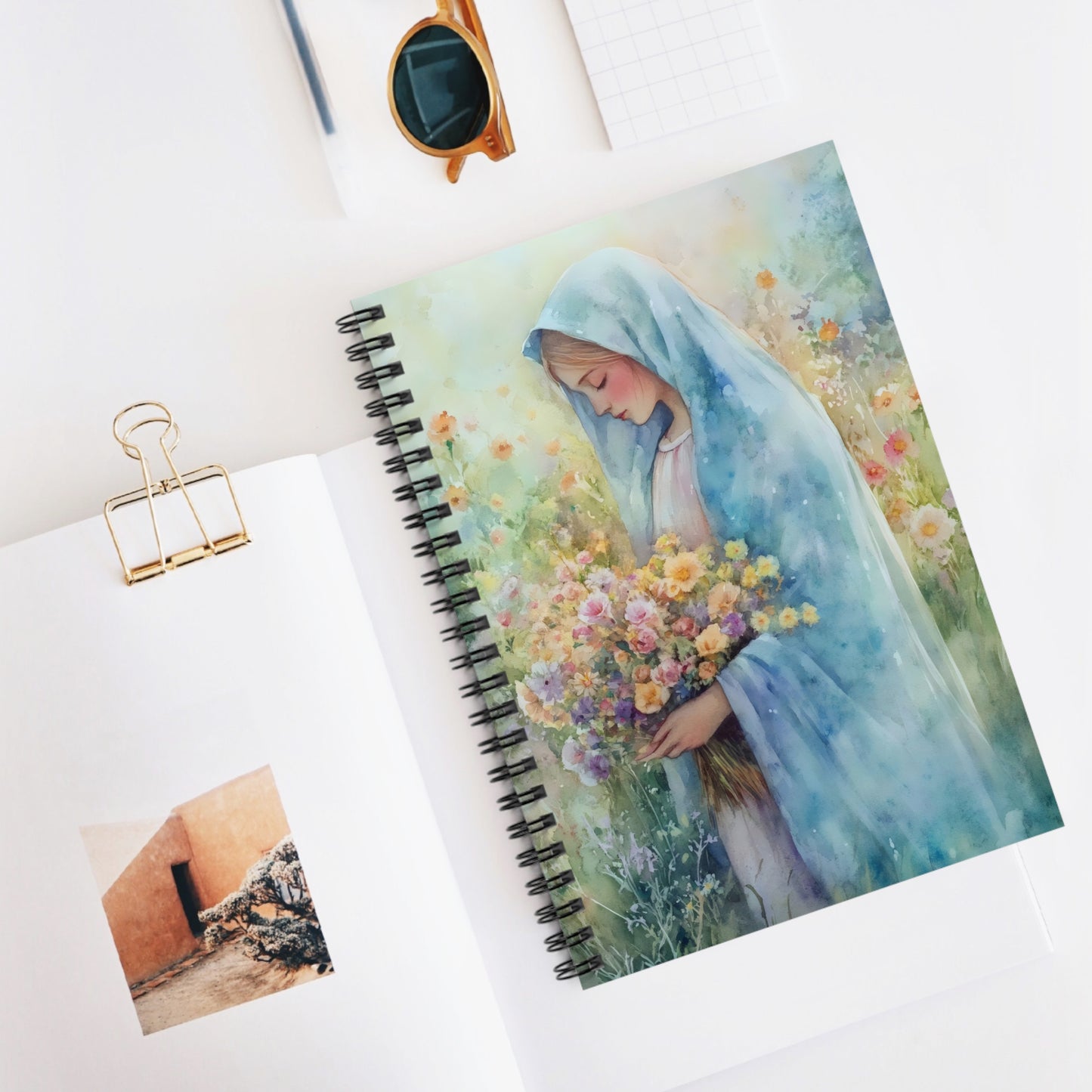 Christian journal with serene woman in blue veil holding flowers, floral watercolor art