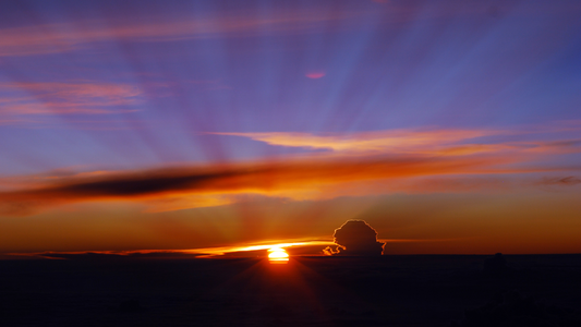 Vibrant sunrise with colorful clouds and radiant sun rays, inspirational nature scene