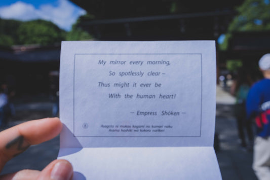 a hand holding a piece of paper with a message
