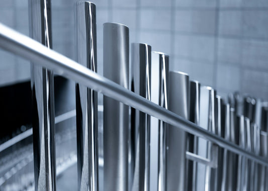 a bunch of stainless steel poles in a room