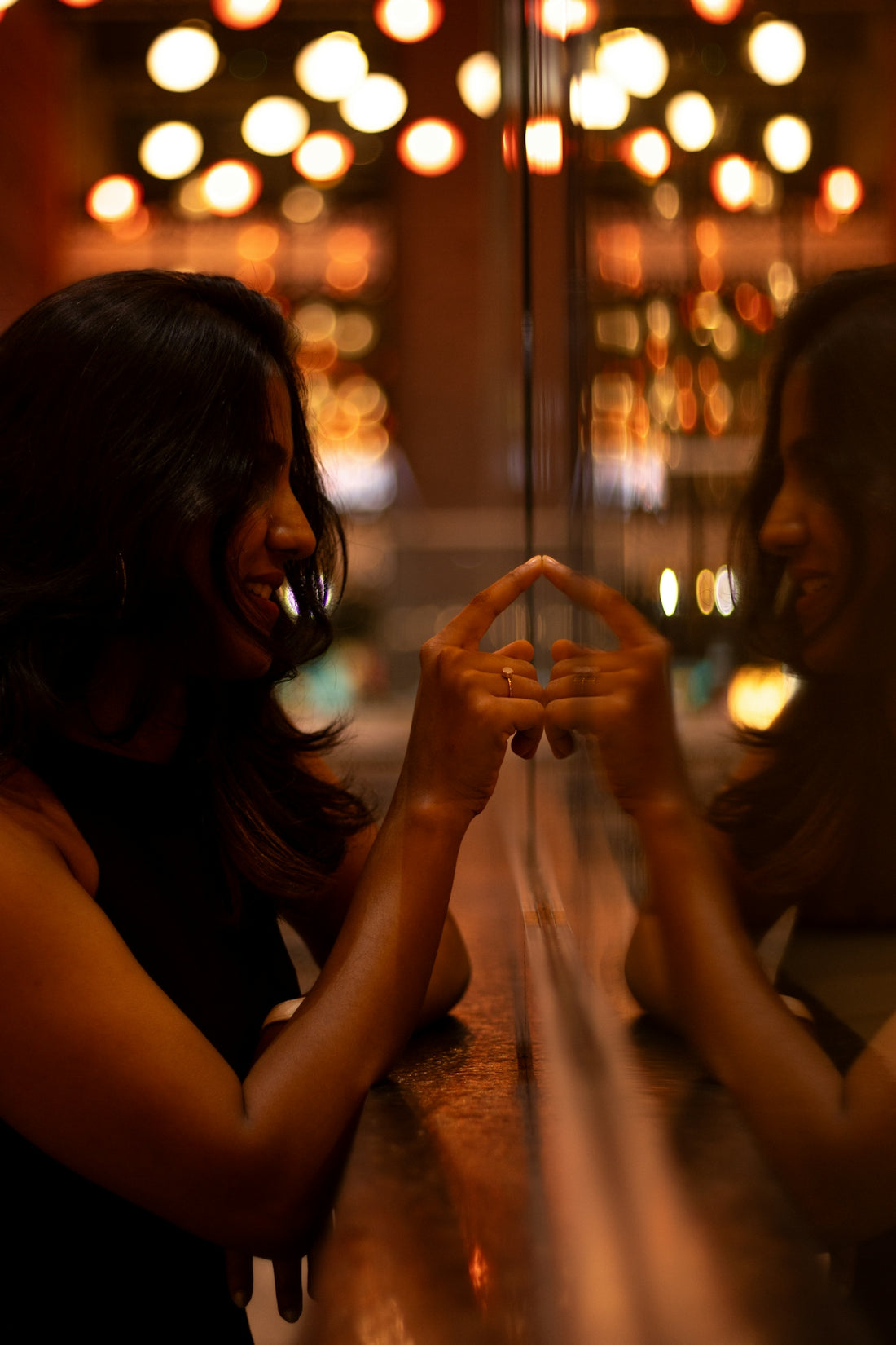 Woman looking at her reflection, making a gesture