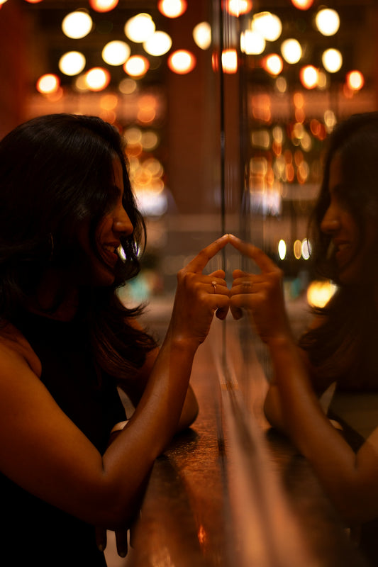 Woman looking at her reflection, making a gesture