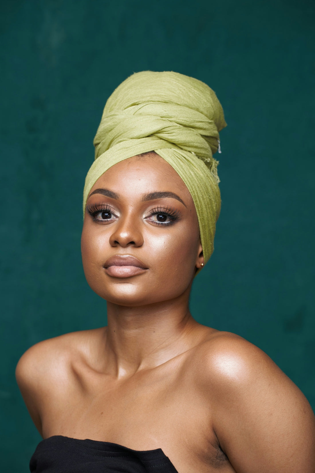 Beautiful woman with head wrap poses for the camera.