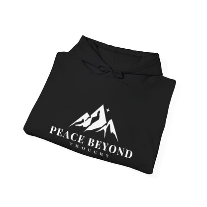 Black hoodie with white mountain graphic and 'Peace Beyond Thought' text folded neatly