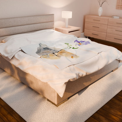 Cozy bedroom with beige bedding featuring a mountain and purple flower art blanket