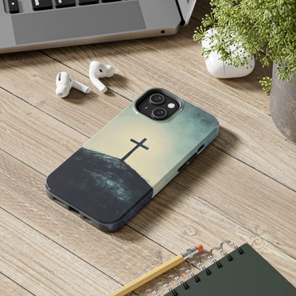 Christian phone case with cross on hill, faith-inspired design on wooden desk with accessories