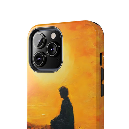 Phone case with silhouette of person meditating against a golden sunrise background
