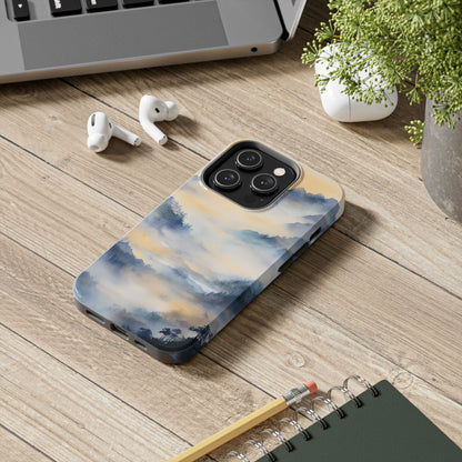 iPhone with faith-inspired watercolor landscape case on wooden desk with accessories