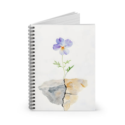 Spiral notebook with watercolor purple flower growing from cracked rock, minimal design