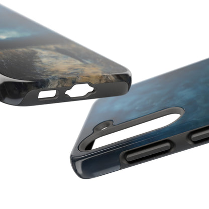 Close-up of two protective phone cases with abstract blue and brown artistic design
