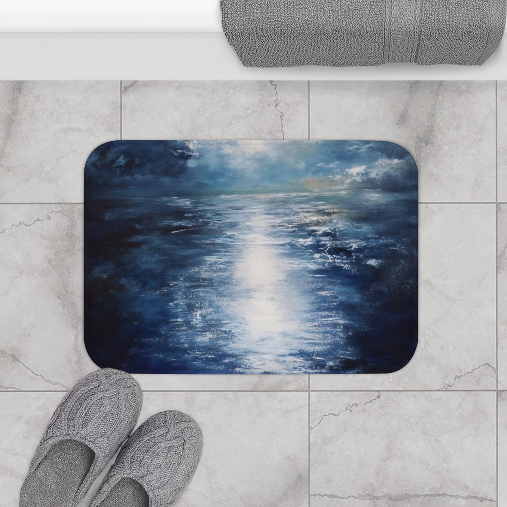 ocean-inspired bath mat with blue and white abstract design on marble bathroom floor