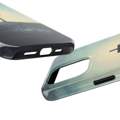 Close-up of two phone cases with serene cross design and soft sunrise colors