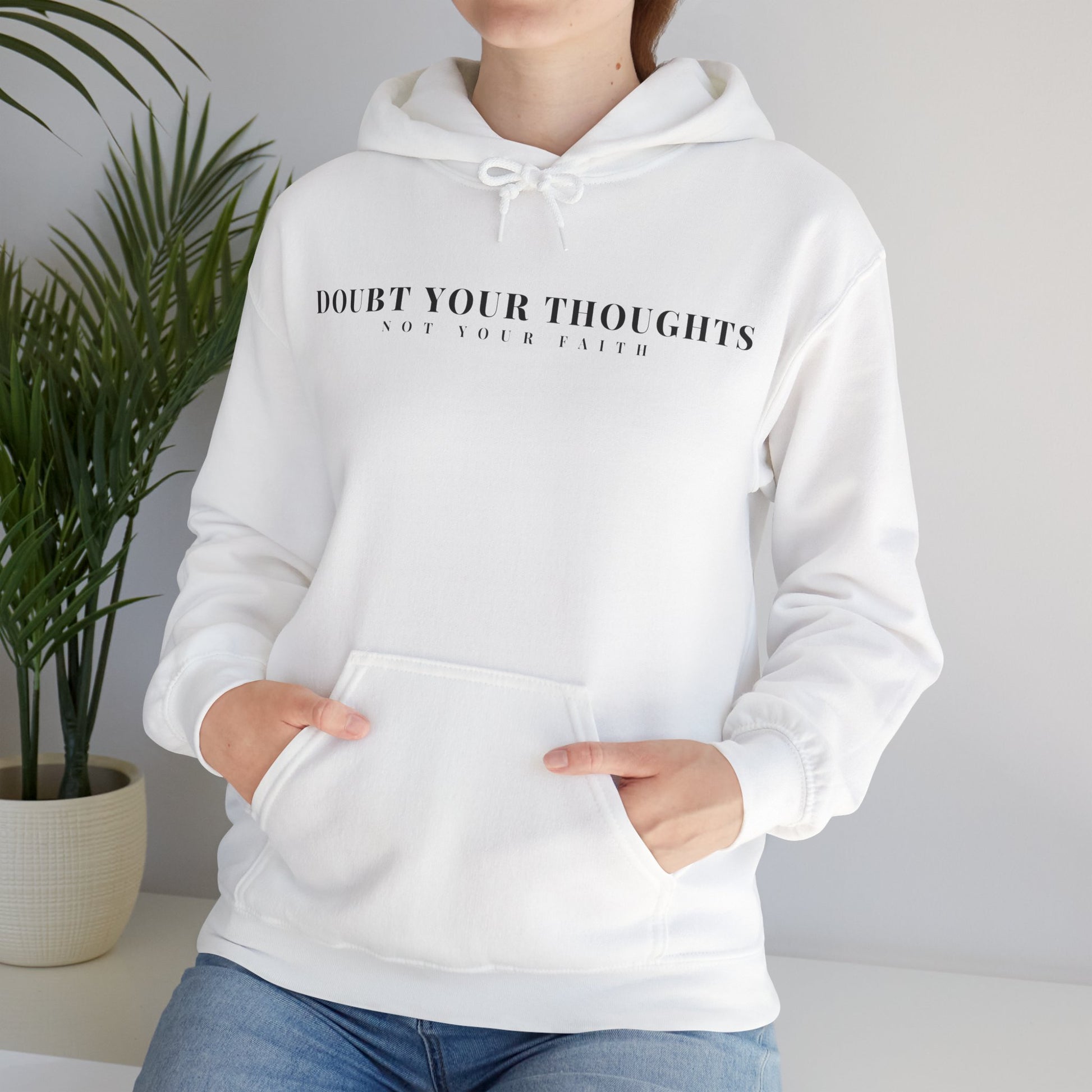 Woman wearing a white Christian hoodie with 'Doubt Your Thoughts Not Your Faith' text design.