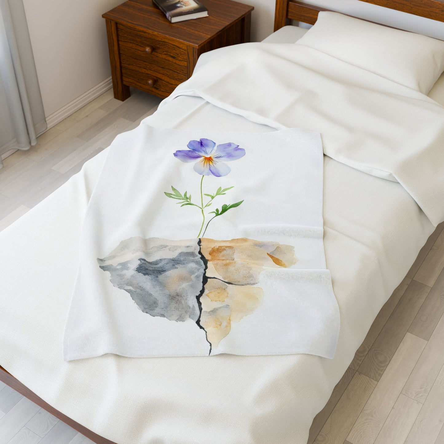 Cozy white bed with a blanket featuring a watercolor purple flower growing through cracked stone, symbolizing faith and resilience.