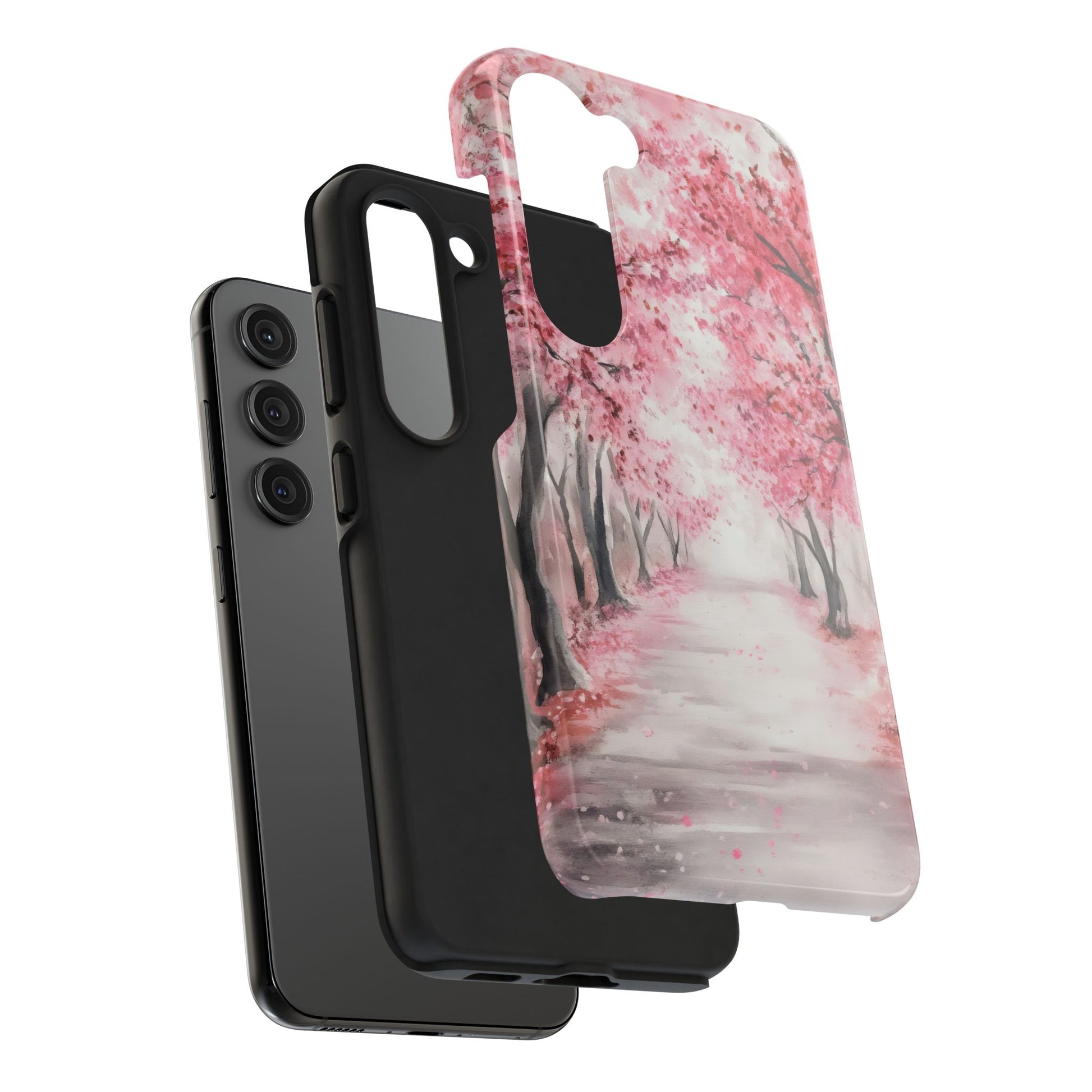Samsung phone with two cases, one solid black and one with pink cherry blossom tree art
