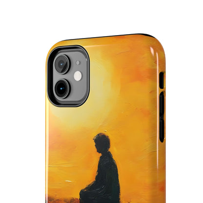Phone case with silhouette of meditating person against warm golden sunrise background