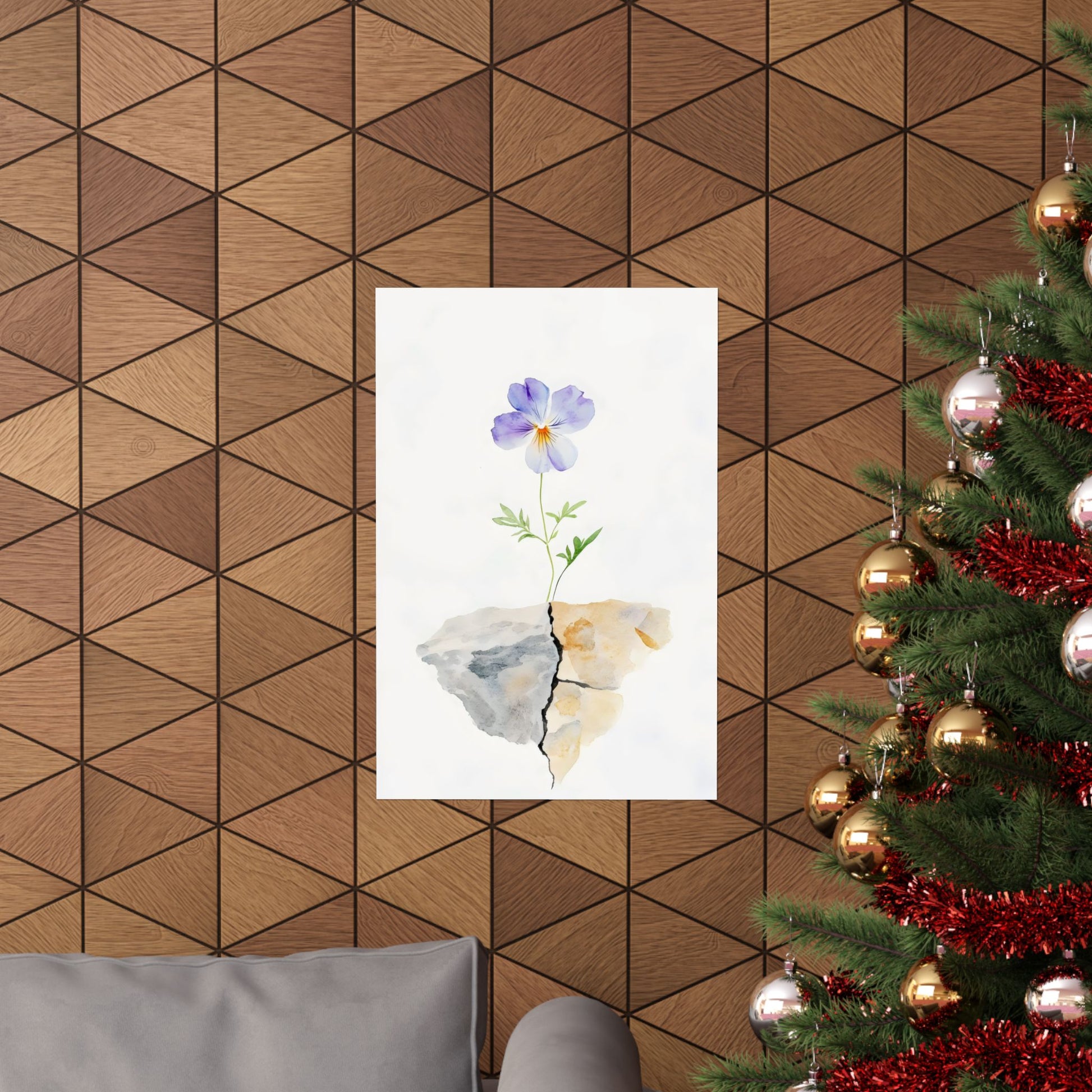Wall art of a purple flower growing through cracked stone, displayed in cozy living room with Christmas tree.
