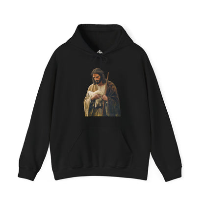 Black hoodie featuring a Christian shepherd holding a lamb, faith-inspired apparel design