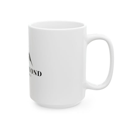 White ceramic mug with partial black faith-inspired text and logo on a plain background