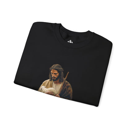 Folded black Christian sweatshirt with an image of Jesus holding a lamb