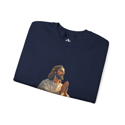 Folded navy blue Christian t-shirt featuring a praying Jesus illustration on the front.