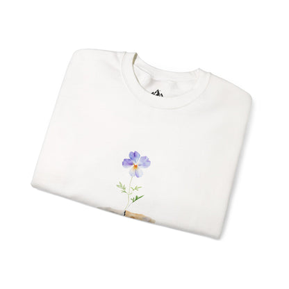 White sweatshirt with a purple flower graphic, folded on a white background