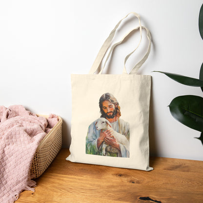 Christian tote bag featuring Jesus holding a lamb, displayed on a wooden table