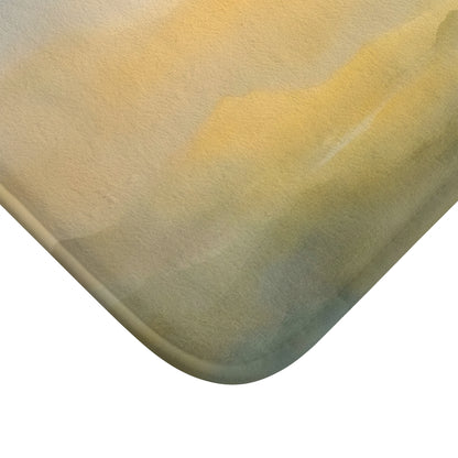 Close-up of soft bath mat corner with serene yellow and green watercolor design