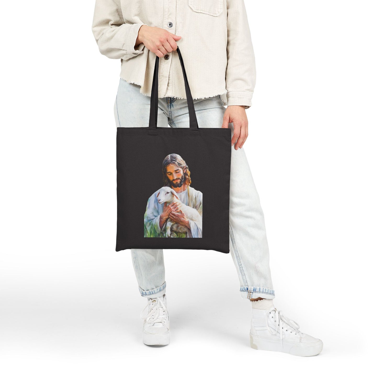 Black tote bag with illustration of Jesus holding a lamb, faith-inspired Christian accessory