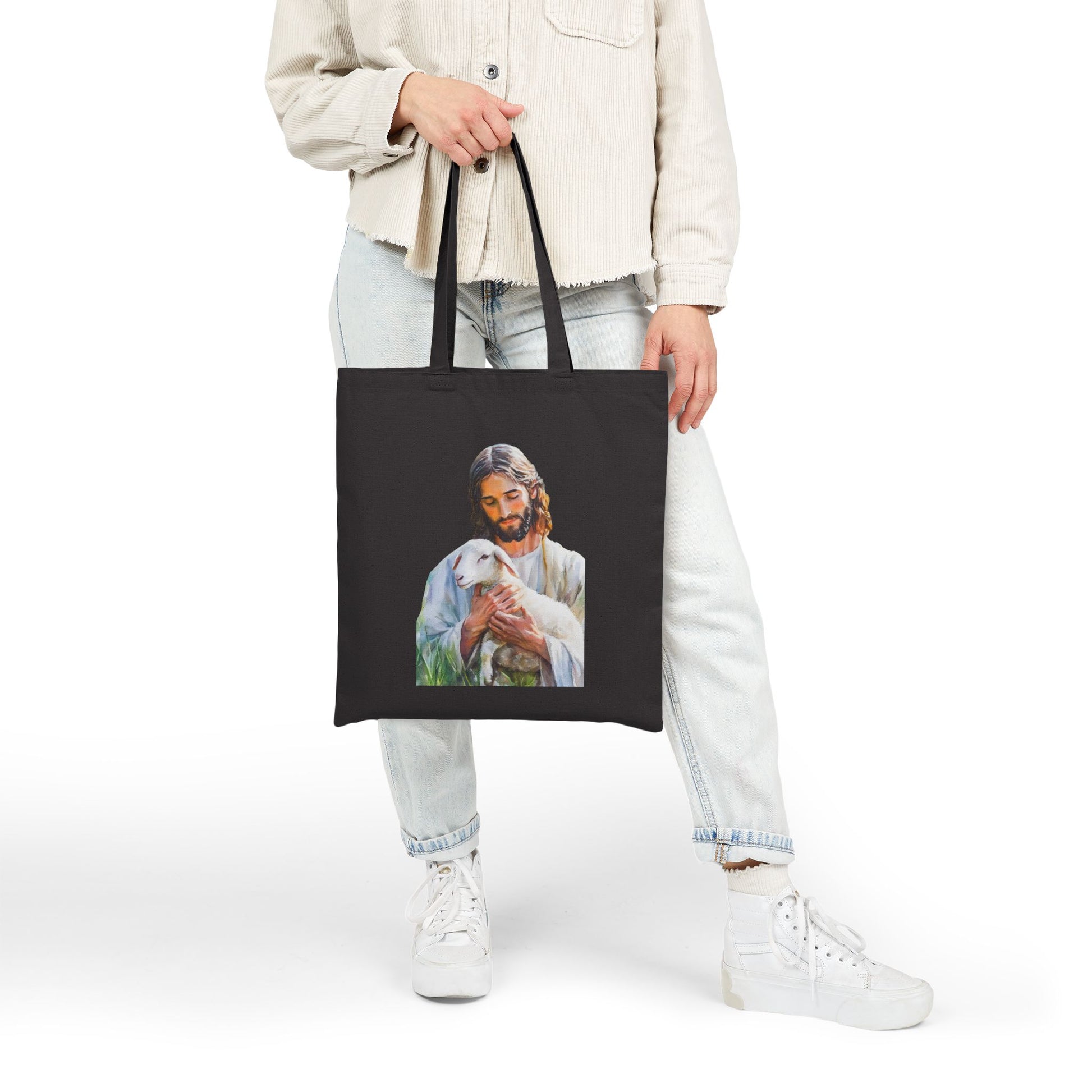 Black tote bag with illustration of Jesus holding a lamb, faith-inspired Christian accessory