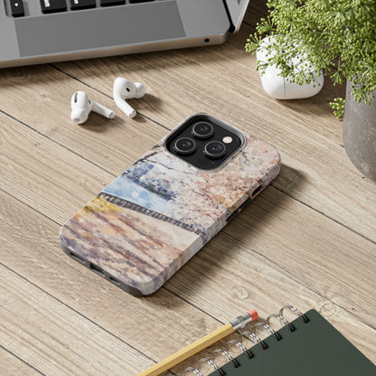 Modern smartphone with abstract Christian-inspired case on rustic wooden desk, next to earphones, notebook, and plant.