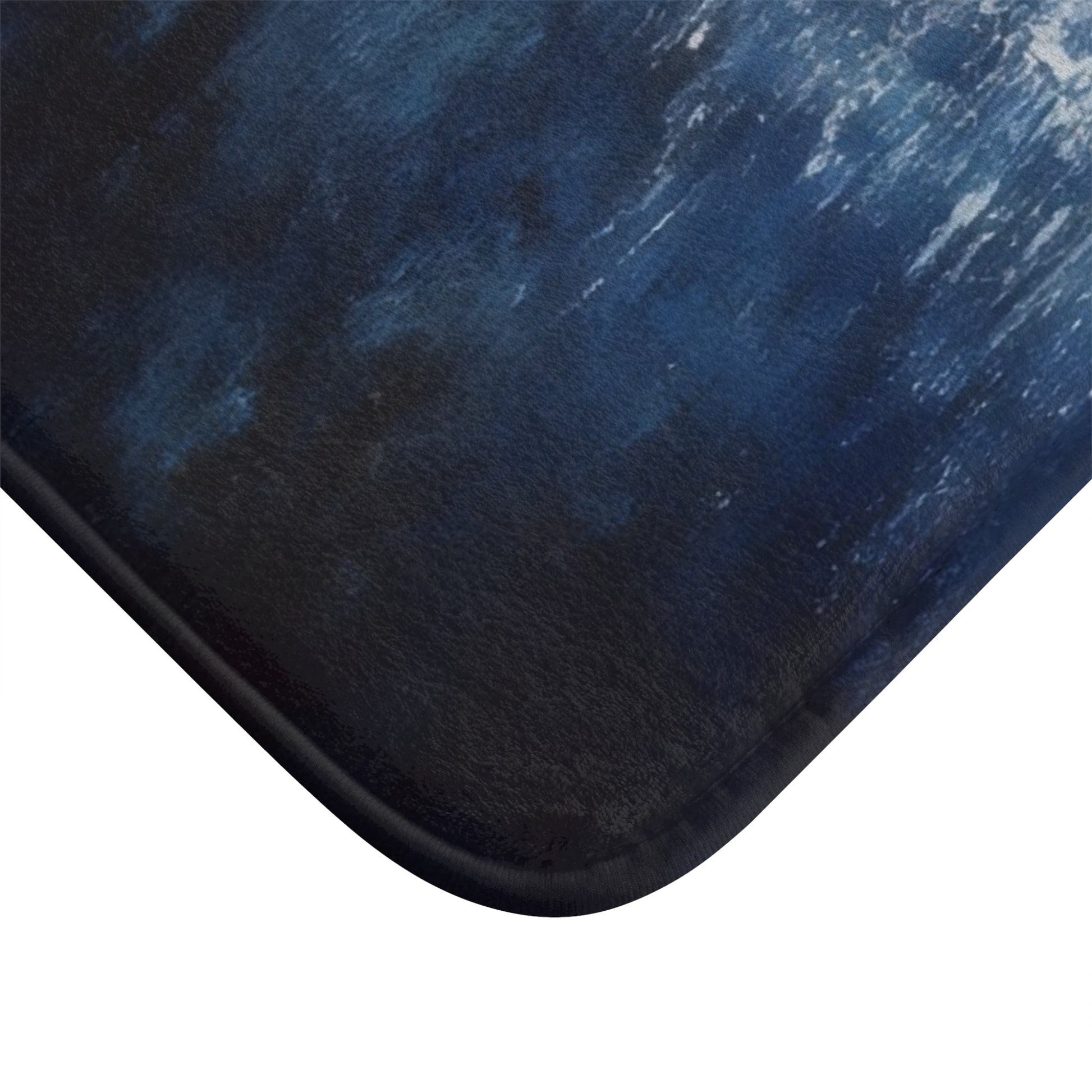 Close-up of a soft bath mat with abstract blue and white artistic pattern