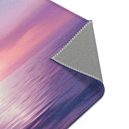 Close-up of a purple and pink abstract ocean wave art rug with stitched fabric edge