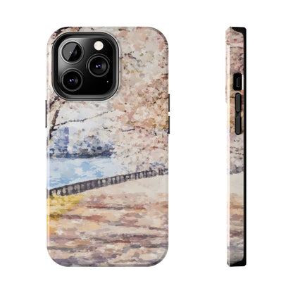 Phone case with watercolor cherry blossom trees by a riverside, soft pastel colors.