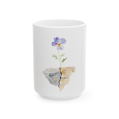 White ceramic mug with watercolor purple flower growing from cracked rock, inspirational design