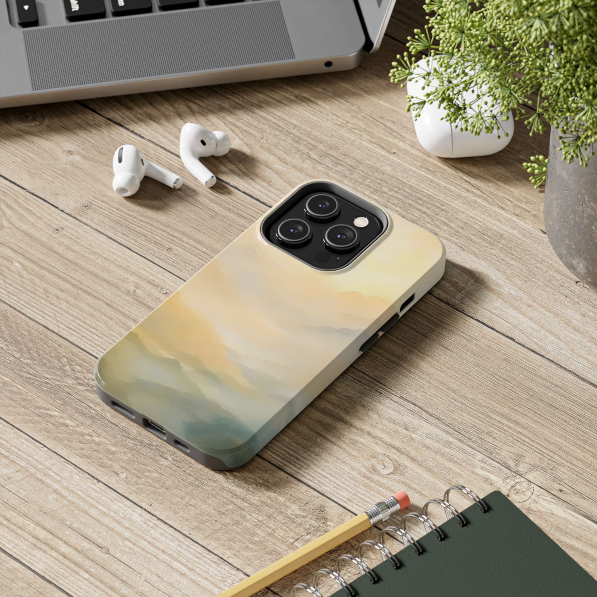 Abstract Christian phone case with serene pastel landscape design on wooden desk