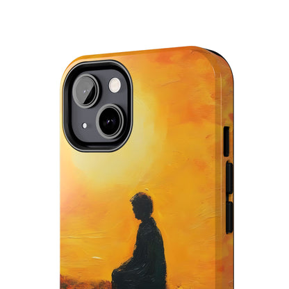 Phone case with silhouette of person meditating against warm yellow and orange sunset background