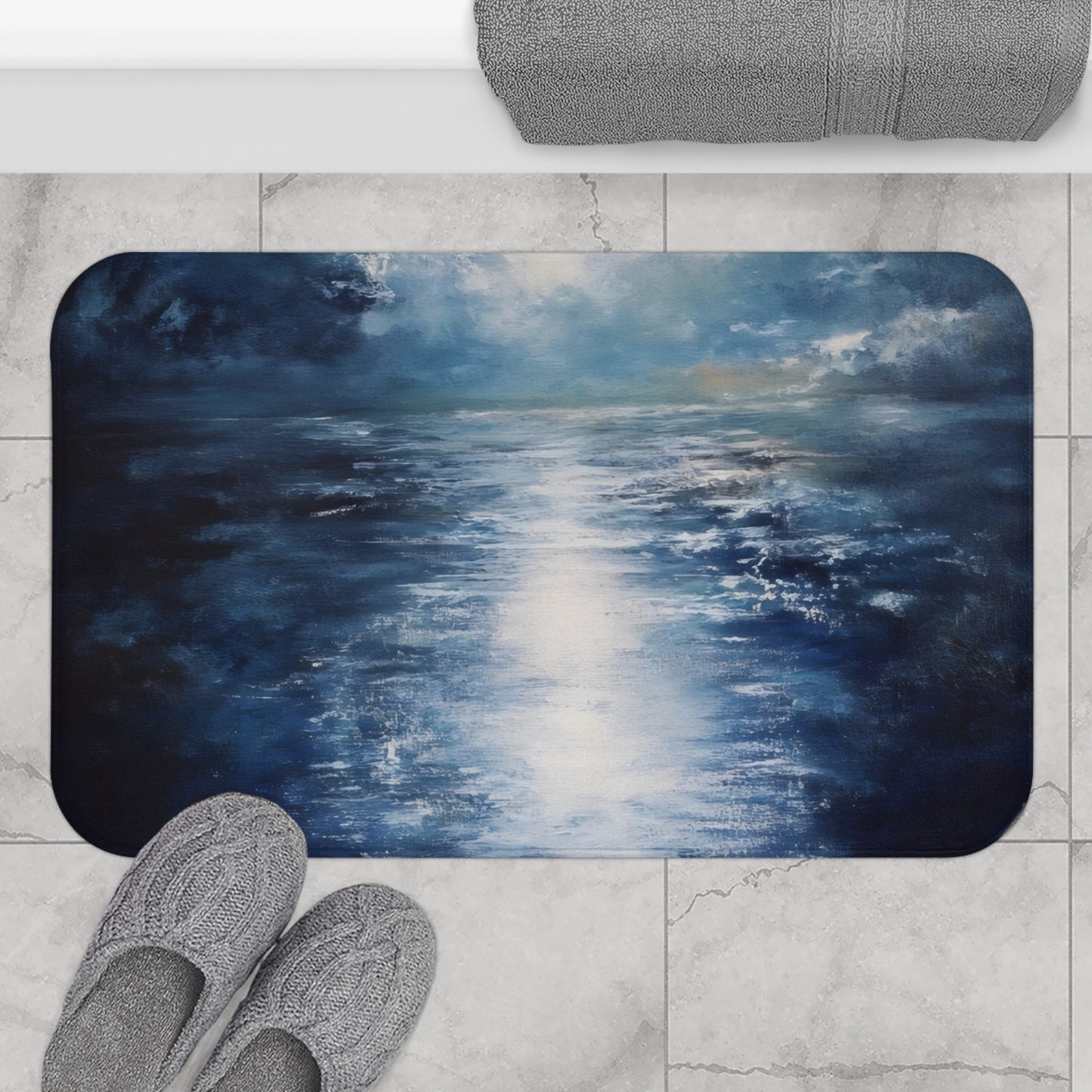 Bathroom mat with serene ocean and sky art design, gray slippers and towel on tile floor
