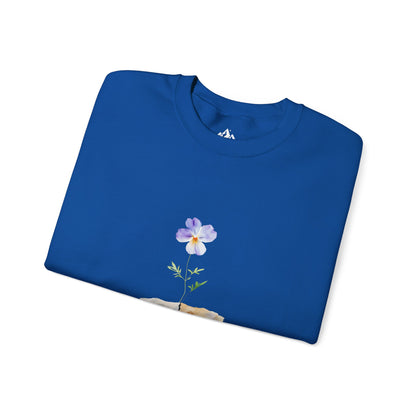 Blue Christian t-shirt with watercolor flower and stone design, folded on white background