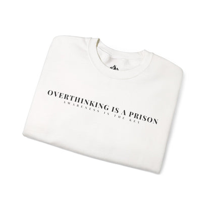 White folded sweatshirt with 'Overthinking is a Prison Awareness is the Key' minimalist text design