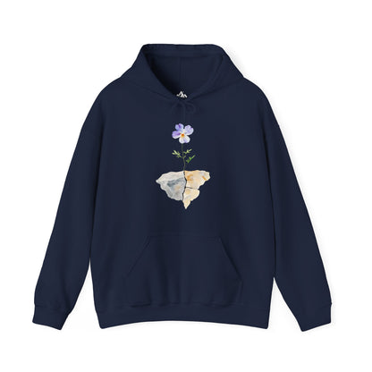 Navy blue hoodie with watercolor flower growing from rocks, minimalist Christian apparel.