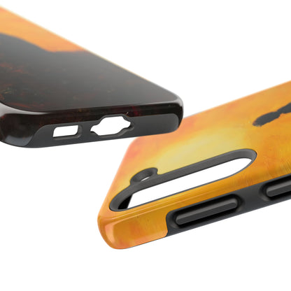 Close-up of two spiritual phone cases with sunset orange and silhouette designs, showing precise cutouts.