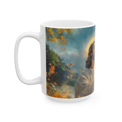 White ceramic mug with Christian art of Jesus in a peaceful autumn landscape, yellow leaves falling.