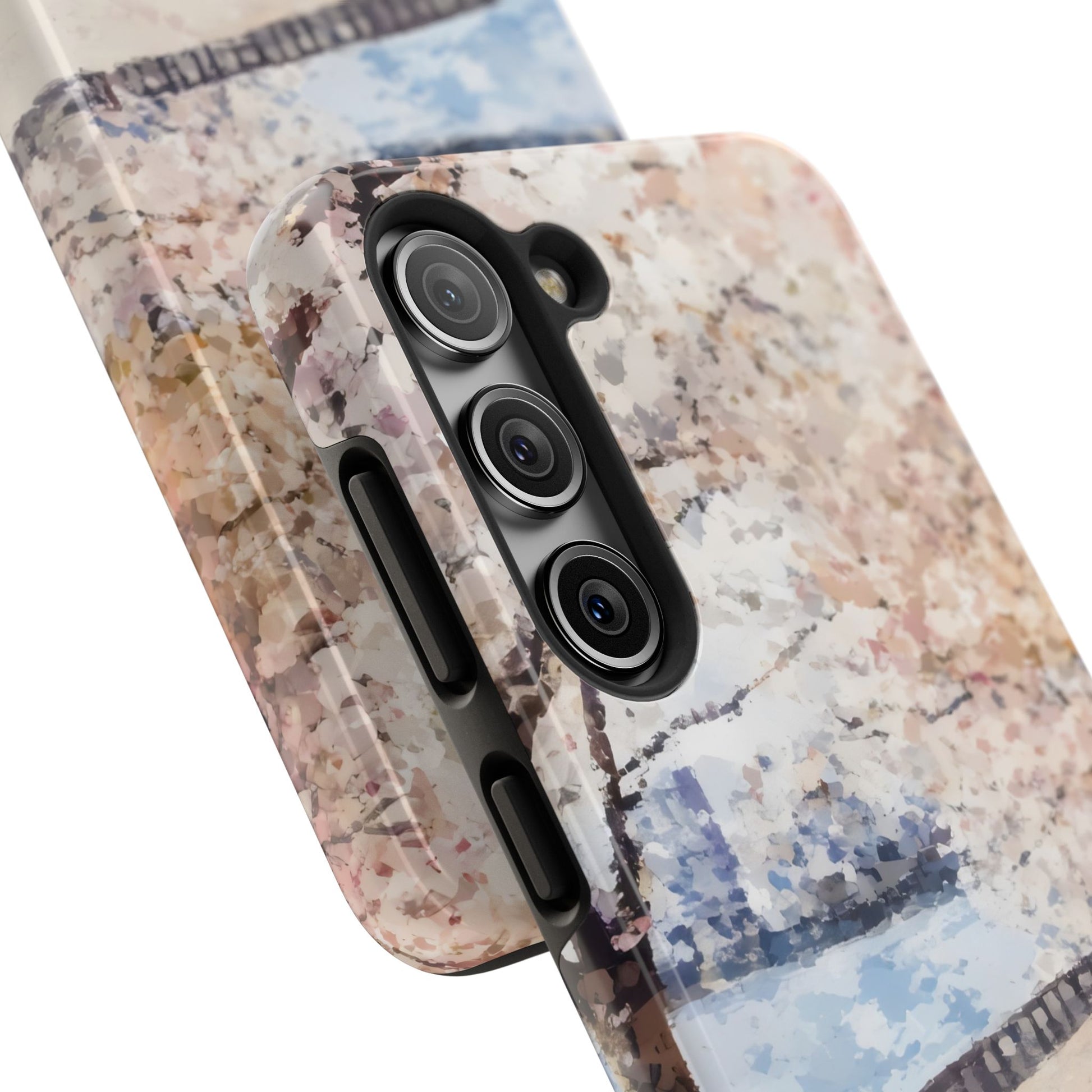 Close-up of smartphone cases with abstract pastel floral art and tree design