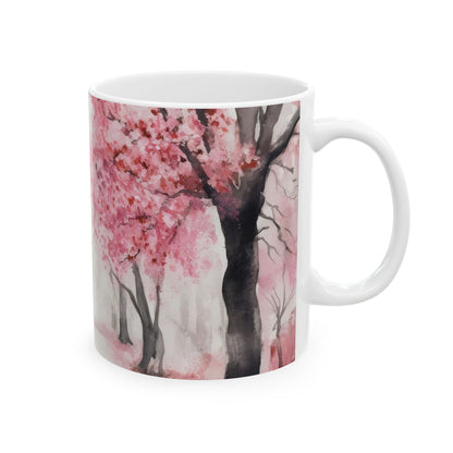 White ceramic mug with watercolor pink cherry blossom tree design, nature-inspired decor