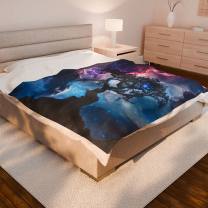 Cozy bedroom with a galaxy-themed blanket featuring a celestial night sky and tree silhouette.