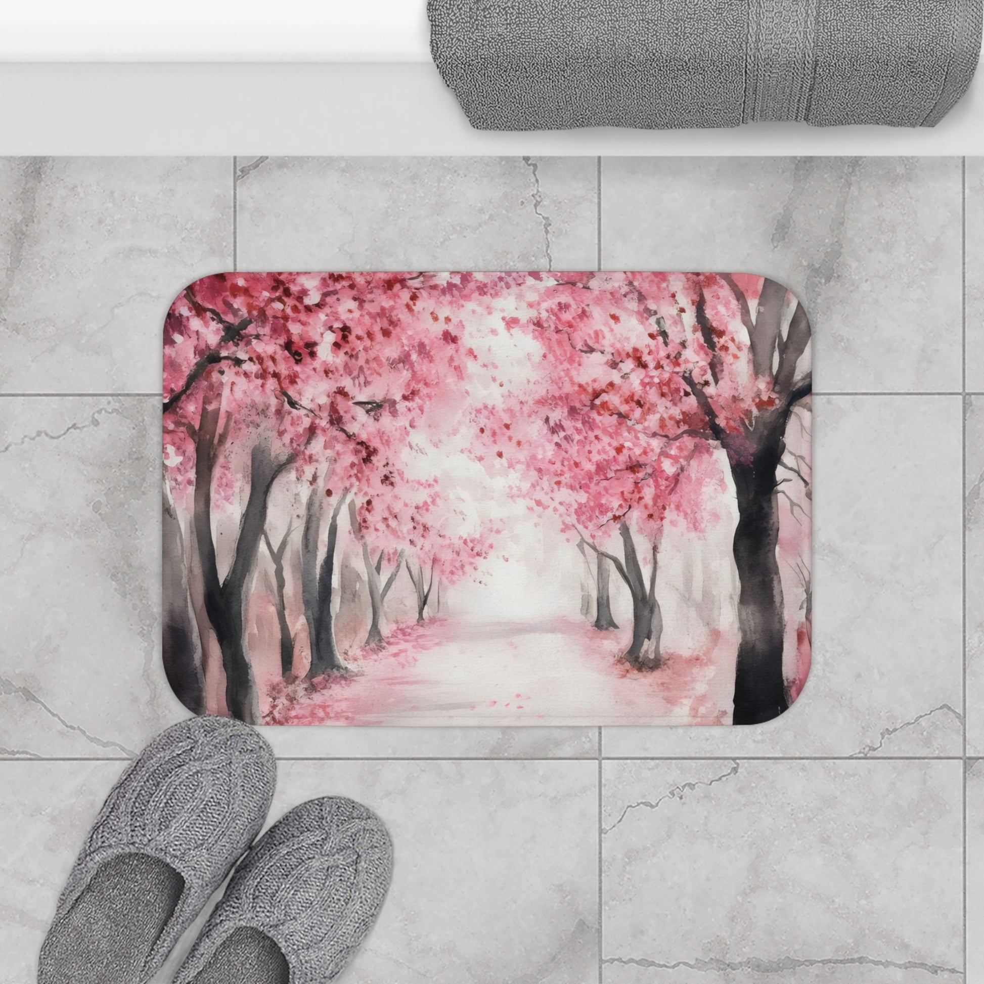 Watercolor pink cherry blossom trees bath mat on marble floor, cozy slippers nearby