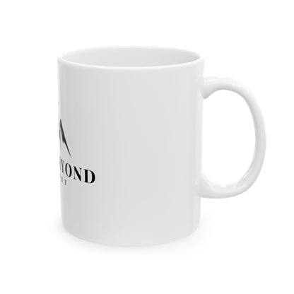 White ceramic mug with partial spiritual mountain design and minimal black text