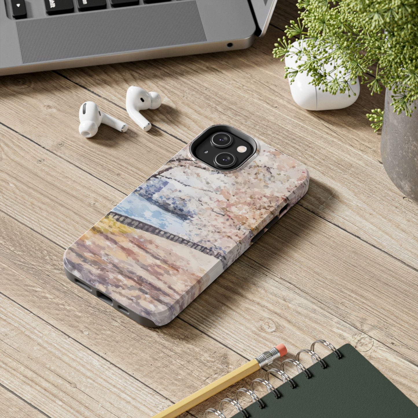 Floral abstract Christian phone case on wooden desk with AirPods, plant, and notebook
