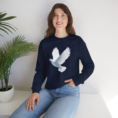 Woman in navy sweatshirt with white dove graphic, sitting by a potted plant